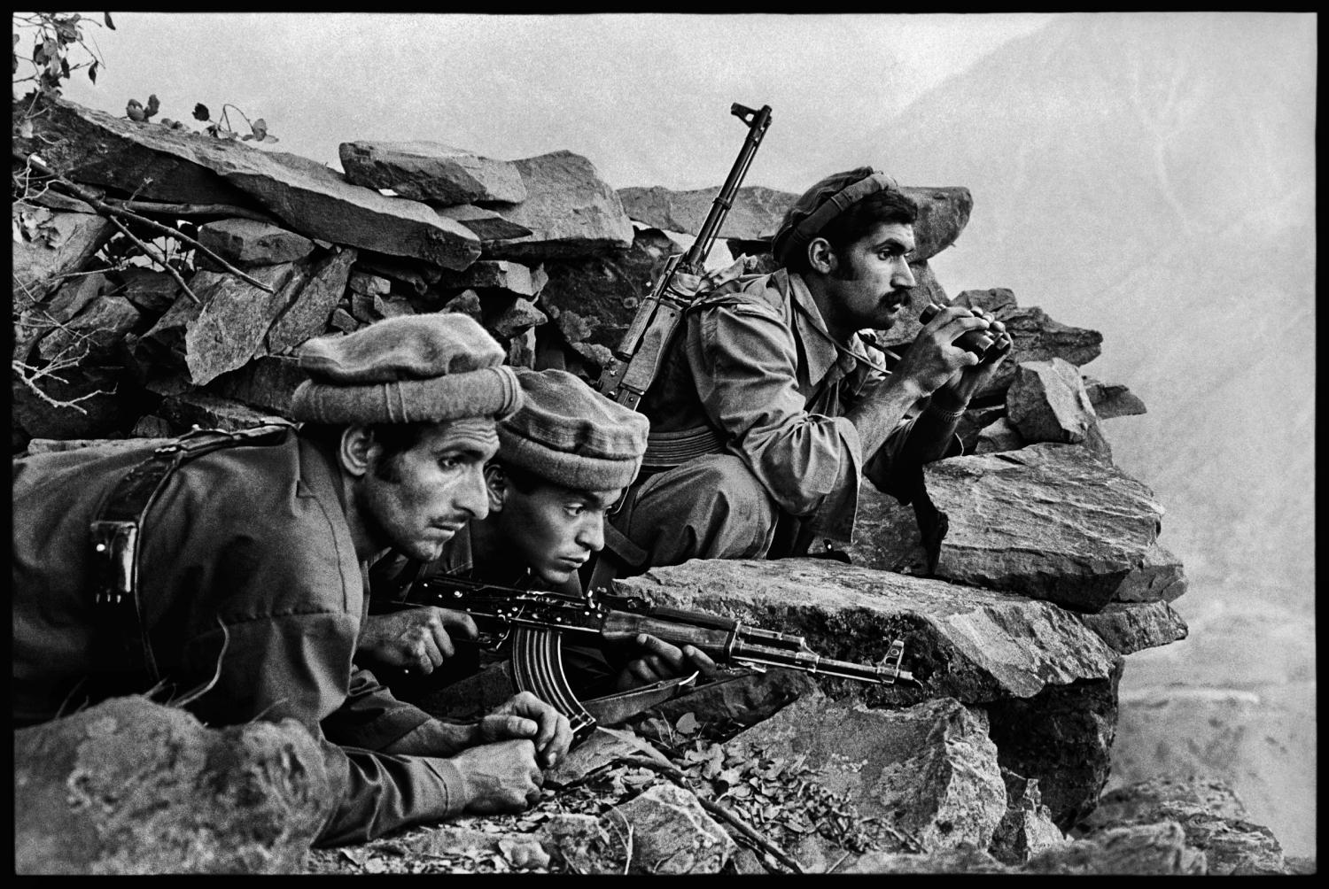 AFGHN-10260, Nuristan, Afghanistan, 1979.  CAPTION:  Mujahideen Watch a Russian Convoy. Nuristan, Afghanistan,1979. Mujahideen fighters watch convoy, 1979"After this photograph was published in The New York Times (in a vertical format), McCurry's career took off. Its publication identified McCurry as a photographer with inside knowledge and contacts as the conflict between the Soviet Union and Afghan nationals expanded. The image also heralded the photographer's intense, poetic approach to telling stories with an economy of means, strategically employing composition, light, and space as narrative tools. Here, for instance, the story is more powerfully told without seeing the Russian convoy the Mujahadeen fighters are so intensely observing, leaving the threat of their presence in mist outside the frame." - Phaidon 55 Mujahideen observe a Russian convoy, Nuristan, Afghanistan, 1979. Pg 16,17, Untold: The Stories Behind the Photographs Magnum Photos, NYC21021, MCS1980002 W00052/00A Steve Mccurry_Book Untold_Book final print_Beetles and Huxley MAX PRINT SIZE: 40X60 retouched_Sonny Fabbri 10/13/2015